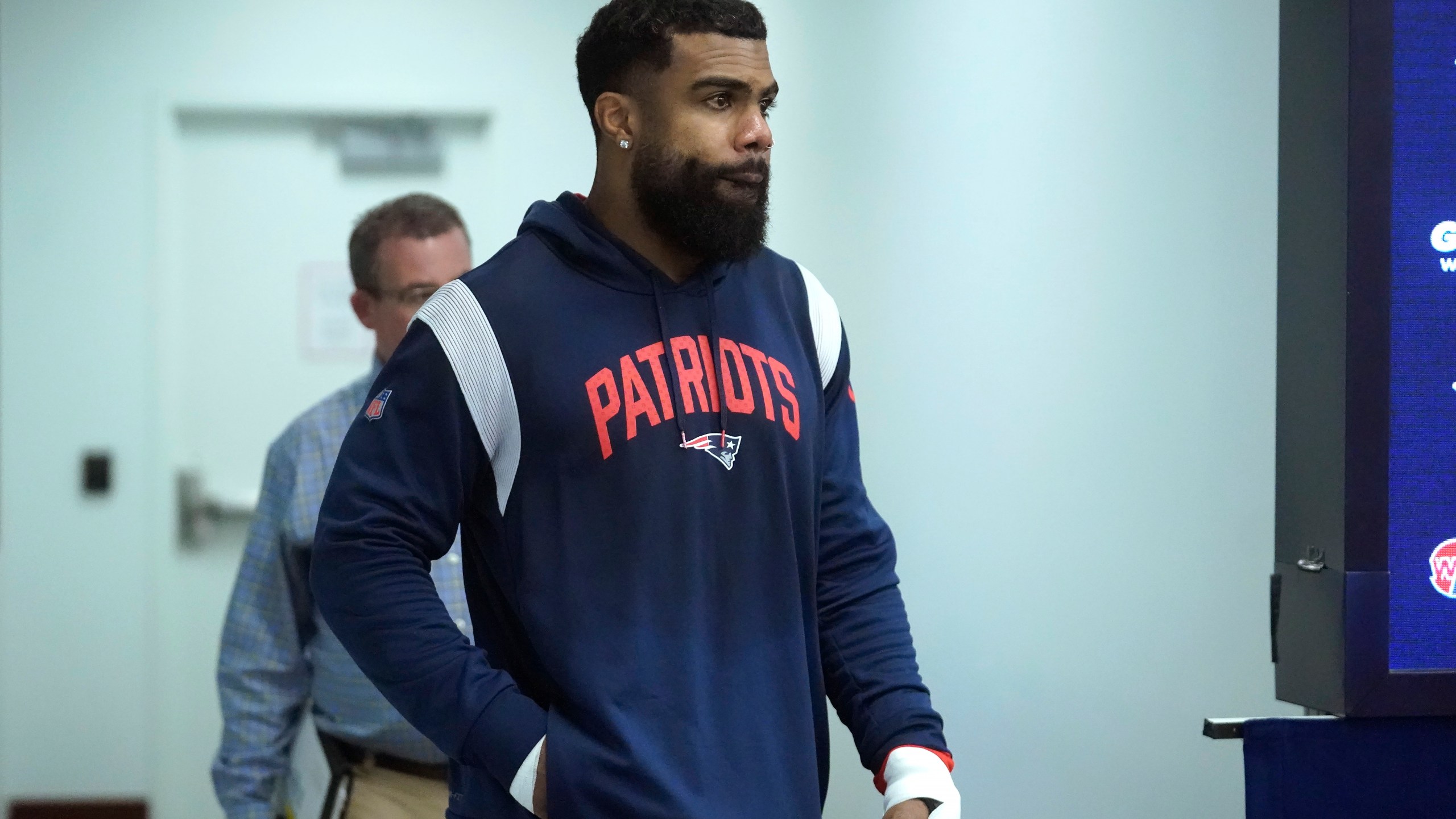 New England Patriots running back Ezekiel Elliott walks toward a podium to face reporters following an NFL football practice, Wednesday, Sept. 27, 2023, in Foxborough, Mass. (AP Photo/Steven Senne)